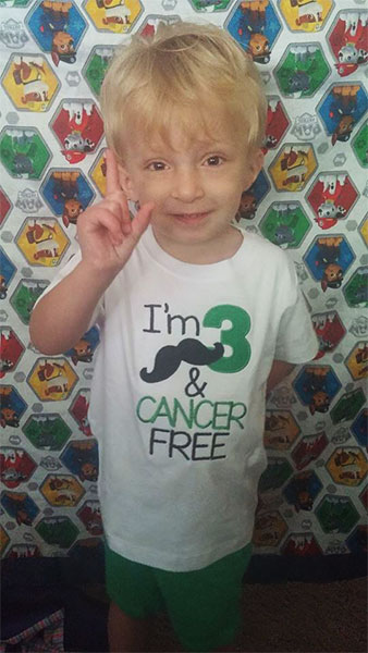 Cole wearing a i'm 3 and cancer free t-shirt